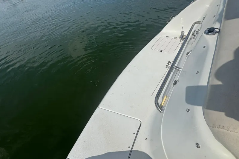 Slide: The Image of 2002 Crownline 239 DB boat deck with railing, floating on calm water. - 27