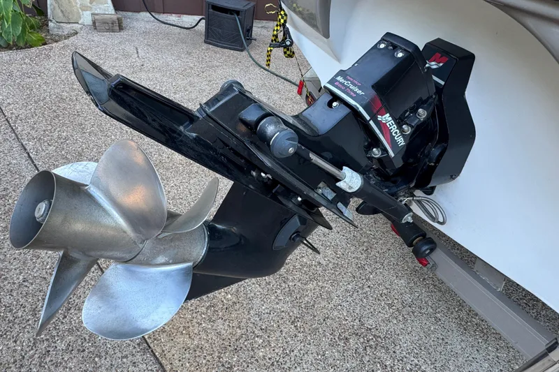 Slide: The Image of 2002 Crownline 239 DB boat cruising on a calm lake under a clear sky. - 3