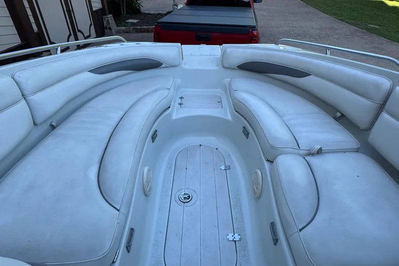 Slide: The Image of 2002 Crownline 239 DB boat on calm water with scenic background. - 5