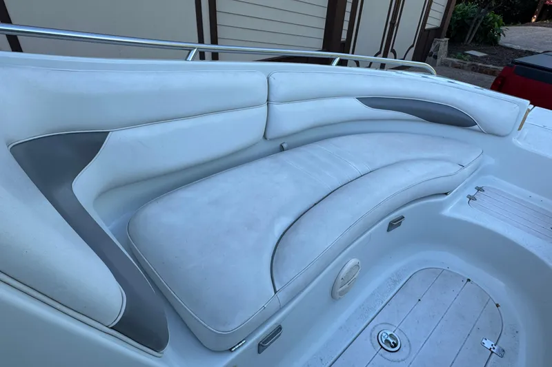 Slide: The Image of 2002 Crownline 239 DB boat on calm water under a partly cloudy sky. - 6