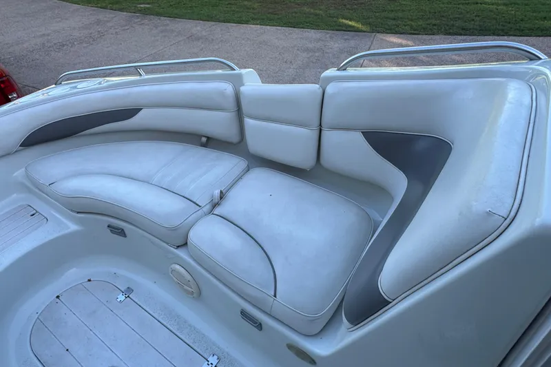 Slide: The Image of 2002 Crownline 239 DB boat on trailer, parked in front of a barn-style building. - 7