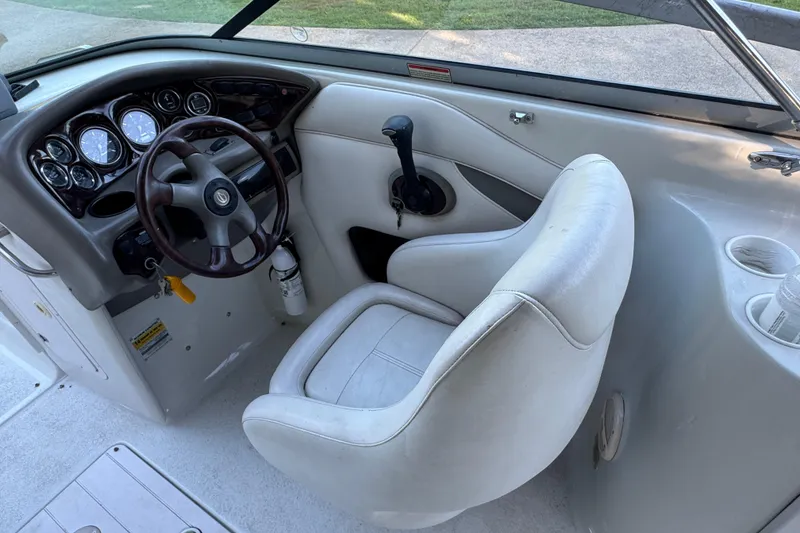 Slide: The Image of 2002 Crownline 239 DB boat on trailer, parked near a building. - 8