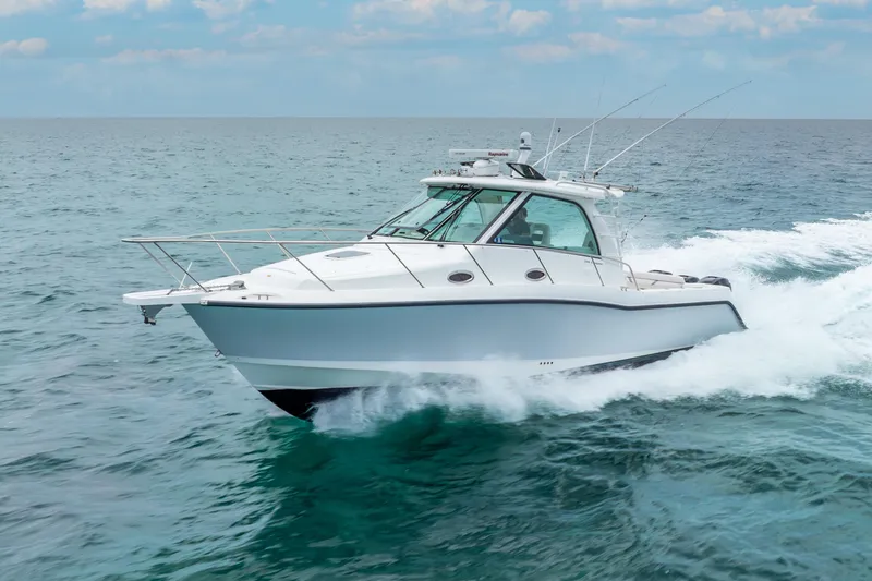 Slide: The Image of 2012 Boston Whaler 345 Conquest cruising on open water. - 11