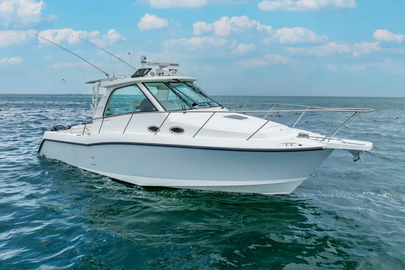 Slide: The Image of 2012 Boston Whaler 345 Conquest boat on open water under blue sky. - 12