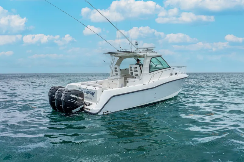 Slide: The Image of 2012 Boston Whaler 345 Conquest boat on open water, clear sky background. - 14
