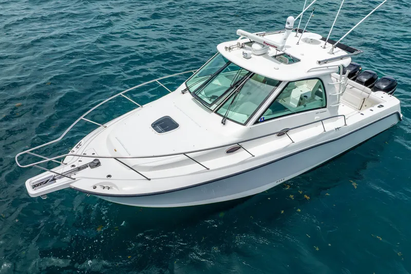 Slide: The Image of 2012 Boston Whaler 345 Conquest boat on clear blue water. - 18