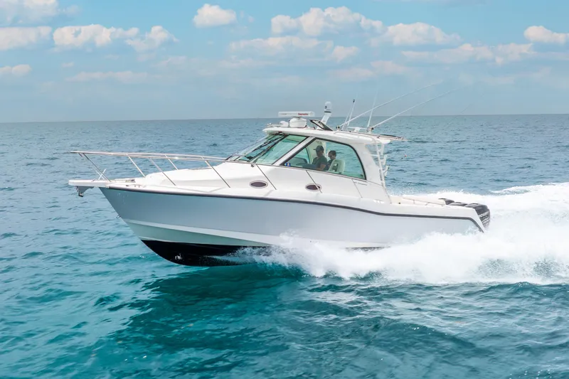 Slide: The Image of 2012 Boston Whaler 345 Conquest cruising on open ocean under clear skies. - 23