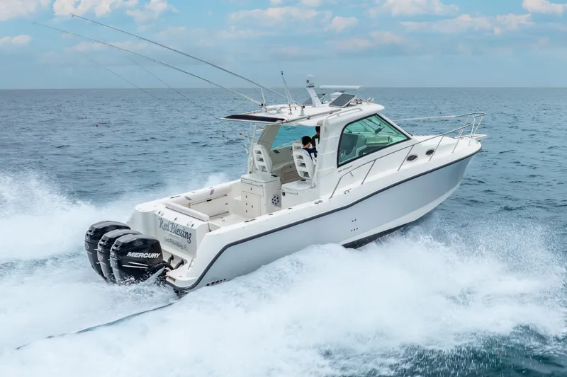 Slide: The Image of 2012 Boston Whaler 345 Conquest cruising on open water with twin Mercury engines. - 3