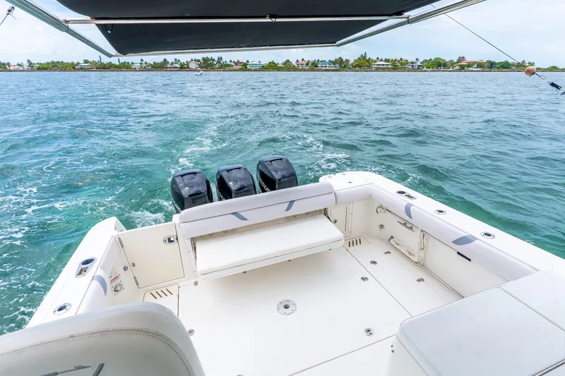 Slide: The Image of Boston Whaler 345 Conquest 2012 boat with triple engines on open water. - 32