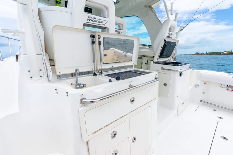 Slide: The Image of 2012 Boston Whaler 345 Conquest boat interior with fishing station and ocean view. - 38