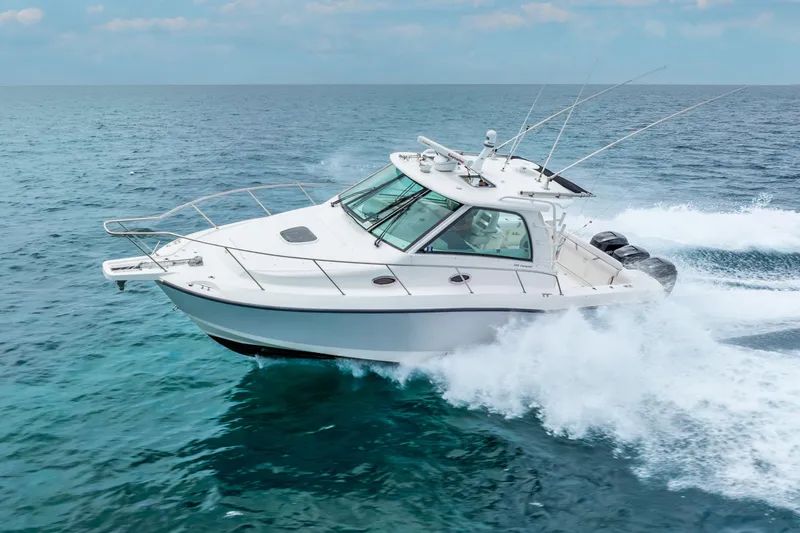 Slide: The Image of 2012 Boston Whaler 345 Conquest cruising on open ocean waters. - 4