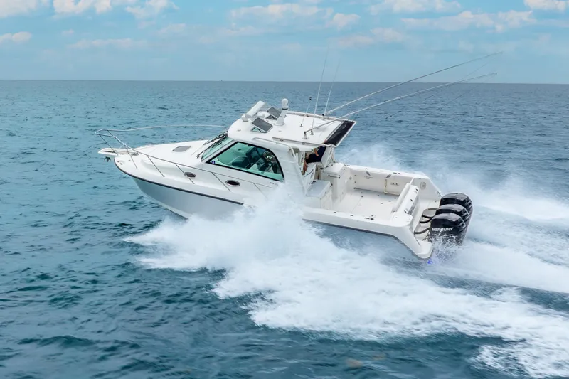 Slide: The Image of 2012 Boston Whaler 345 Conquest cruising on open water, showcasing powerful performance. - 5