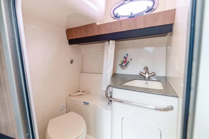 Slide: The Image of 2012 Boston Whaler 345 Conquest bathroom with sink, toilet, and storage. - 50