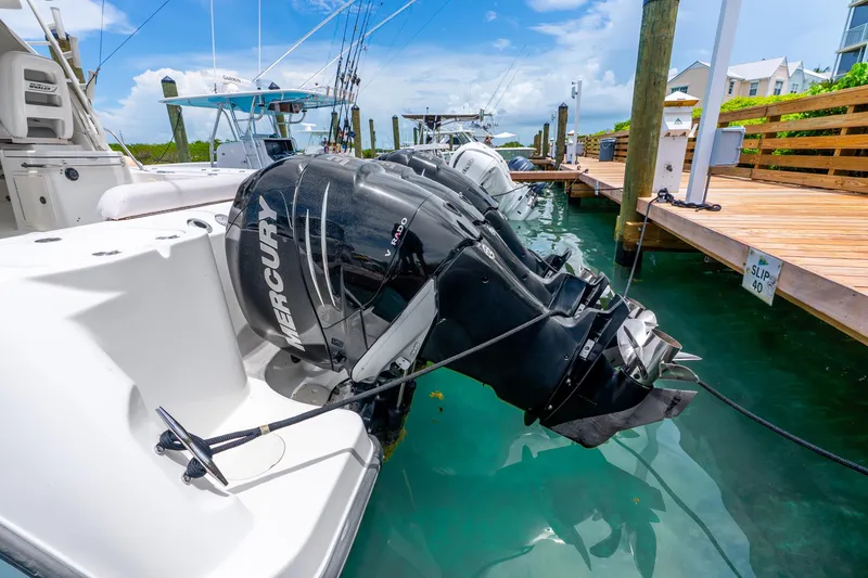 Slide: The Image of Boston Whaler 345 Conquest 2012 with Mercury outboard engine docked at marina. - 51