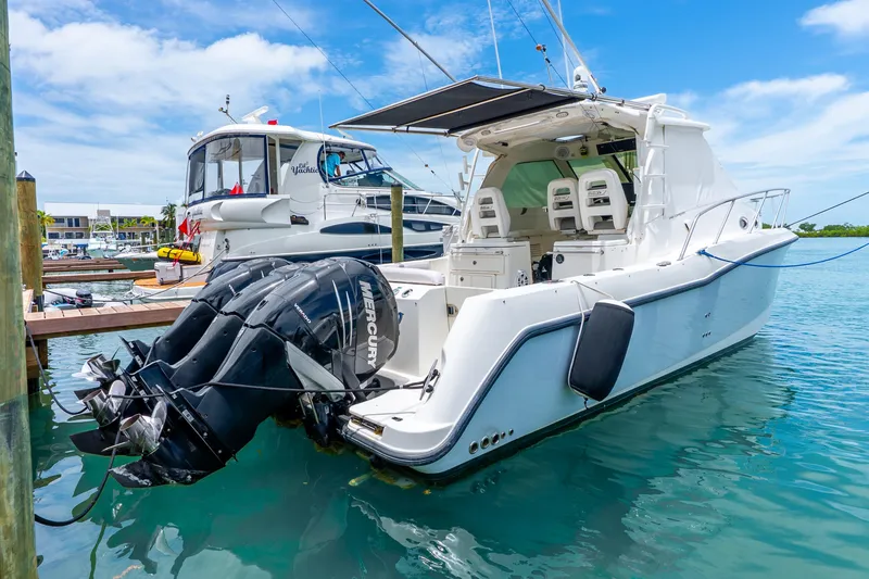 Slide: The Image of 2012 Boston Whaler 345 Conquest docked, featuring powerful Mercury outboard engines. - 53