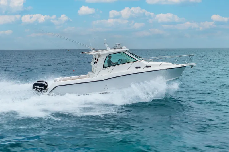 Slide: The Image of 2012 Boston Whaler 345 Conquest cruising on open sea under blue sky. - 8