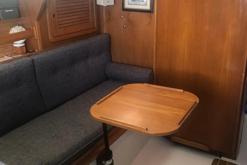 Slide: The Image of Interior of 1996 Catalina 30 MkIII sailboat with wooden table and cushioned seating. - 17