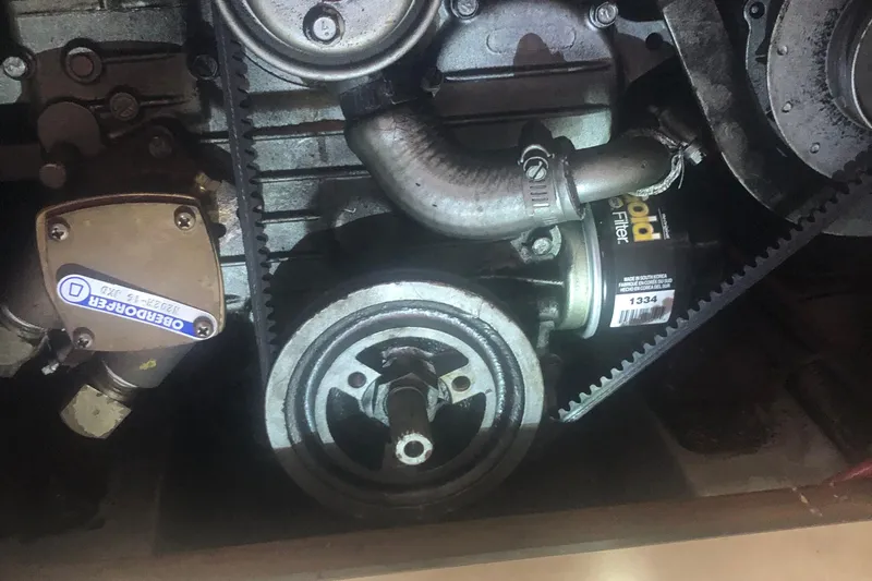 Slide: The Image of Engine components of a 1996 Catalina 30 MkIII, featuring a belt and oil filter. - 21