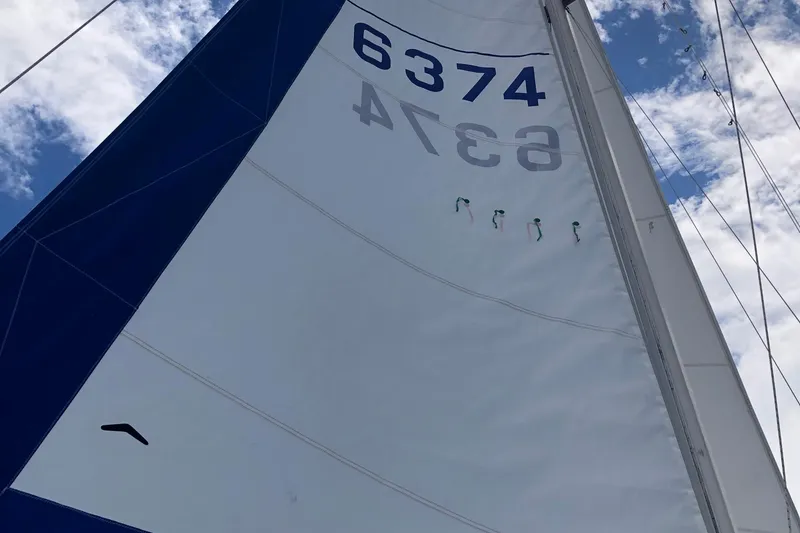 Slide: The Image of Sail of a 1996 Catalina 30 MkIII against a partly cloudy sky. - 26