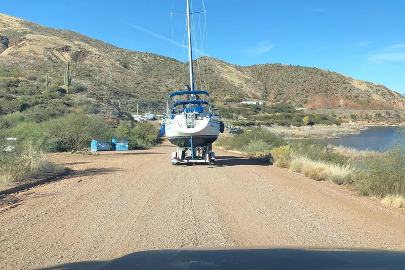 Slide: The Image of 1996 Catalina 30 MkIII sailboat on trailer, desert landscape, dirt road, clear blue sky. - 27