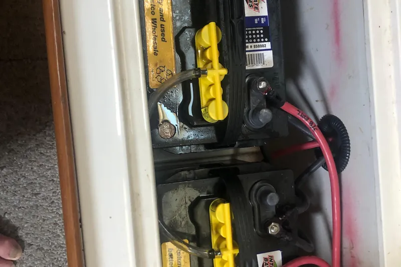 Slide: The Image of Batteries in a 1996 Catalina 30 MkIII boat, connected with red and black cables. - 30