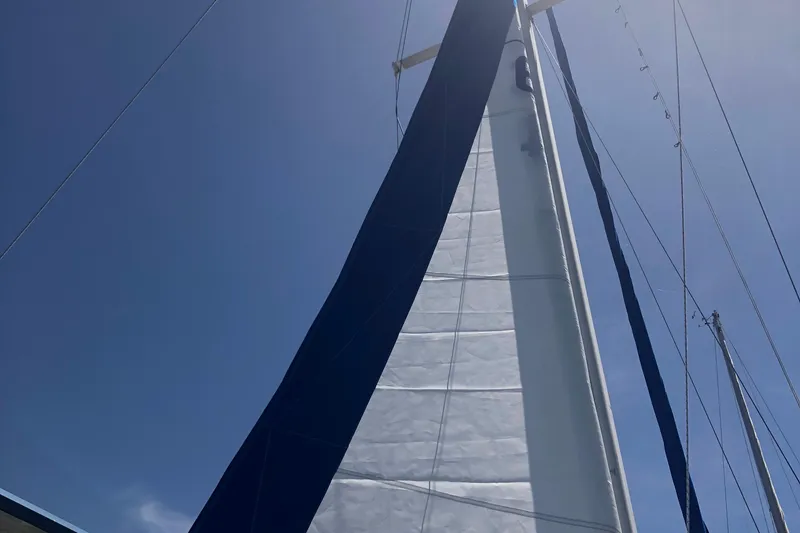 Slide: The Image of Sail of a 1996 Catalina 30 MkIII against a clear blue sky. - 32