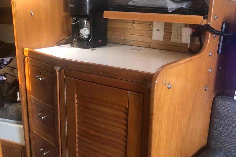 Slide: The Image of Interior of 1996 Catalina 30 MkIII sailboat with wooden cabinetry and coffee maker. - 36