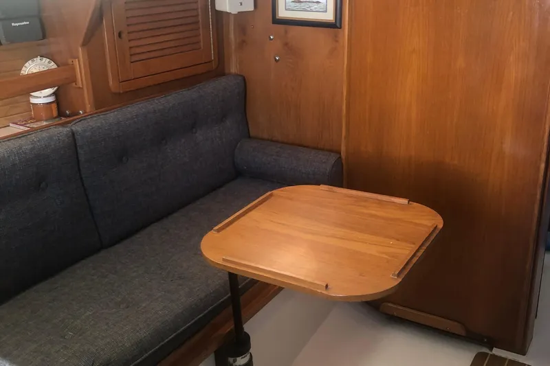 Slide: The Image of Cozy interior of 1996 Catalina 30 MkIII sailboat with wooden table and cushioned seating. - 38