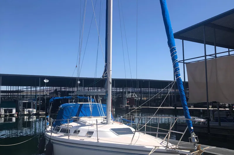 Slide: The Image of 1996 Catalina 30 MkIII sailboat docked at marina under clear blue sky. - 47