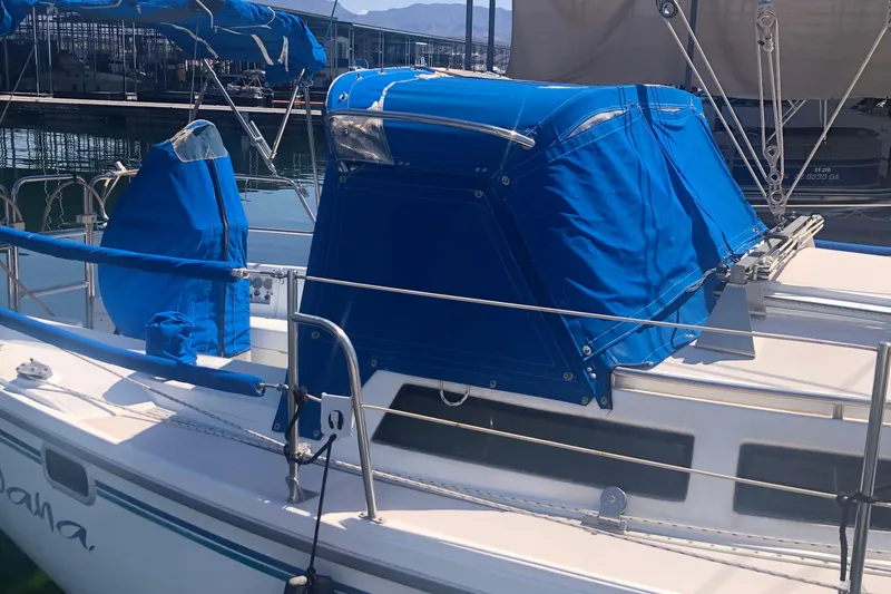 Slide: The Image of 1996 Catalina 30 MkIII sailboat with blue covers docked at marina. - 51