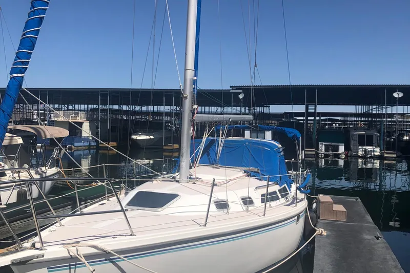 Slide: The Image of 1996 Catalina 30 MkIII sailboat docked at a marina under clear blue skies. - 52