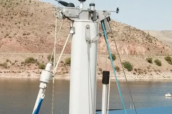 Slide: The Image of Mast of 1996 Catalina 30 MkIII sailboat with rigging, set against a lake and hillside. - 54