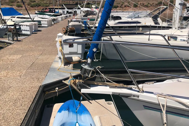 Slide: The Image of Catalina 30 MkIII sailboat docked at marina, 1996 model, with blue kayak on deck. - 55