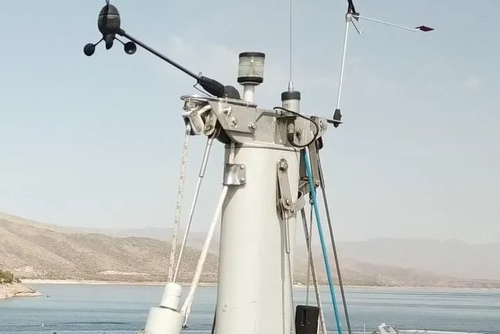 Slide: The Image of Mast of 1996 Catalina 30 MkIII sailboat with wind instruments, against a lake backdrop. - 56