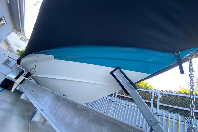 Slide: The Image of 2009 Century 3200 Offshore boat on trailer, covered and secured outdoors. - 10