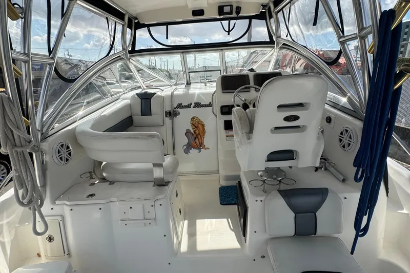 Slide: The Image of Interior of a 2009 Century 3200 Offshore boat with white seating and steering area. - 17