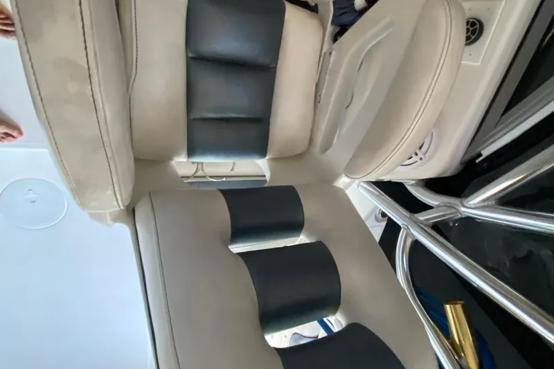 Slide: The Image of 2009 Century 3200 Offshore boat interior seating with black and beige upholstery. - 22