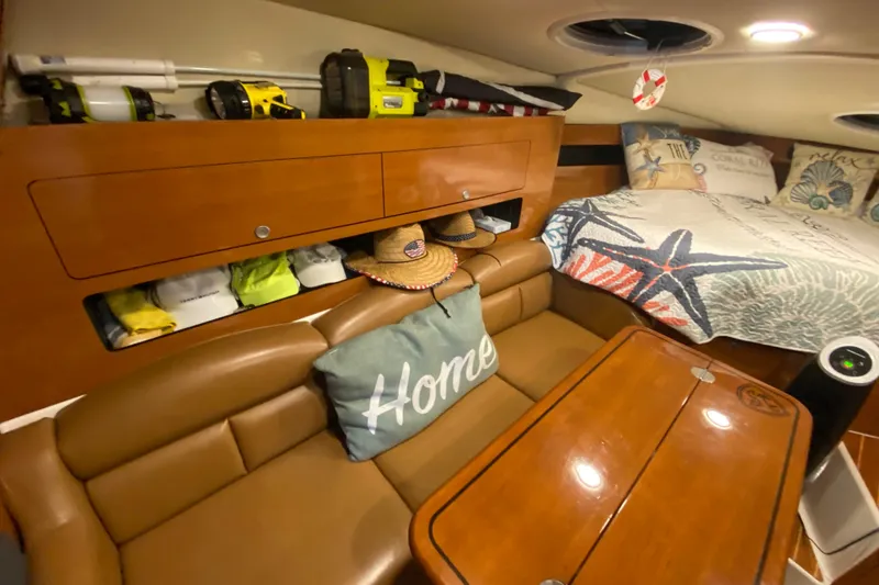 Slide: The Image of Interior of a 2009 Century 3200 Offshore boat with cozy seating and nautical decor. - 26