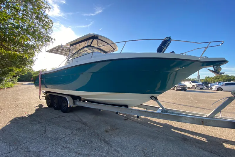 Slide: The Image of 2009 Century 3200 Offshore boat on trailer under clear blue sky. - 3