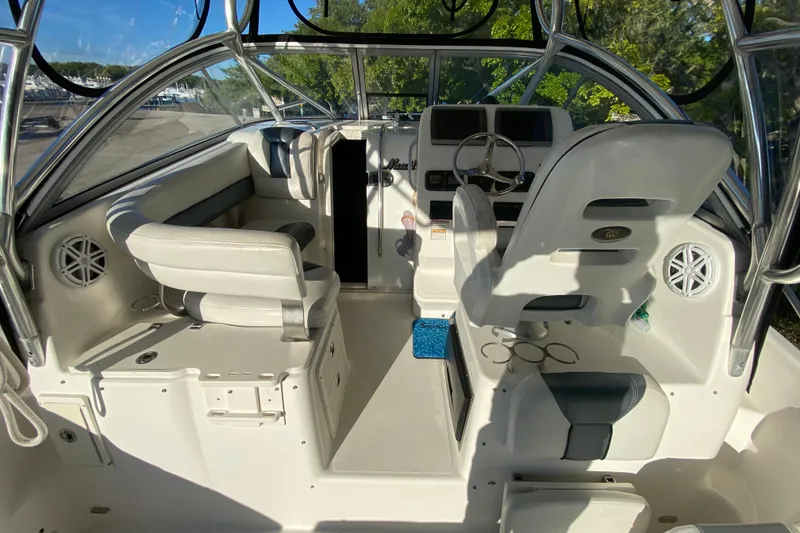 Slide: The Image of 2009 Century 3200 Offshore boat interior with steering wheel and seating. - 37