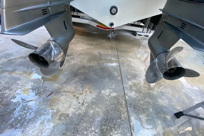 Slide: The Image of Twin propellers of a 2009 Century 3200 Offshore boat on a wet concrete surface. - 44
