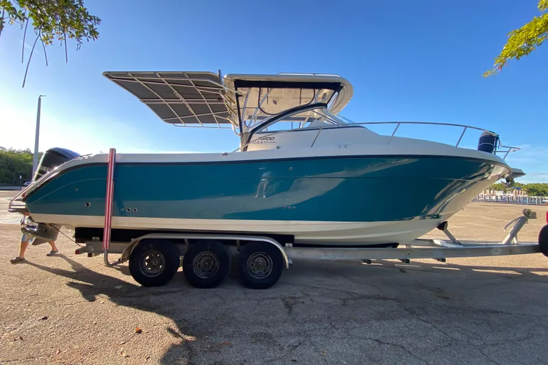 Slide: The Image of 2009 Century 3200 Offshore boat on trailer, sunny day, side view. - 5