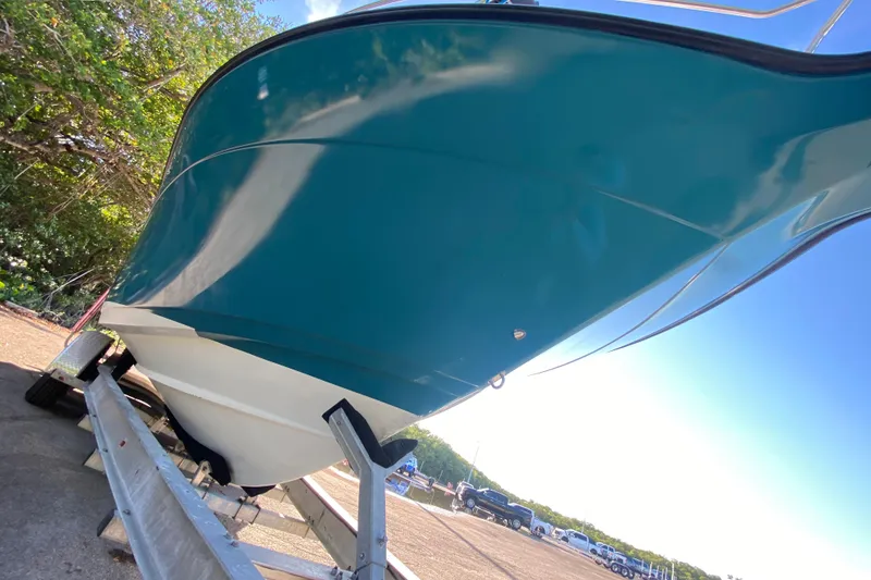 Slide: The Image of 2009 Century 3200 Offshore boat on trailer, vibrant blue hull, sunny day. - 6