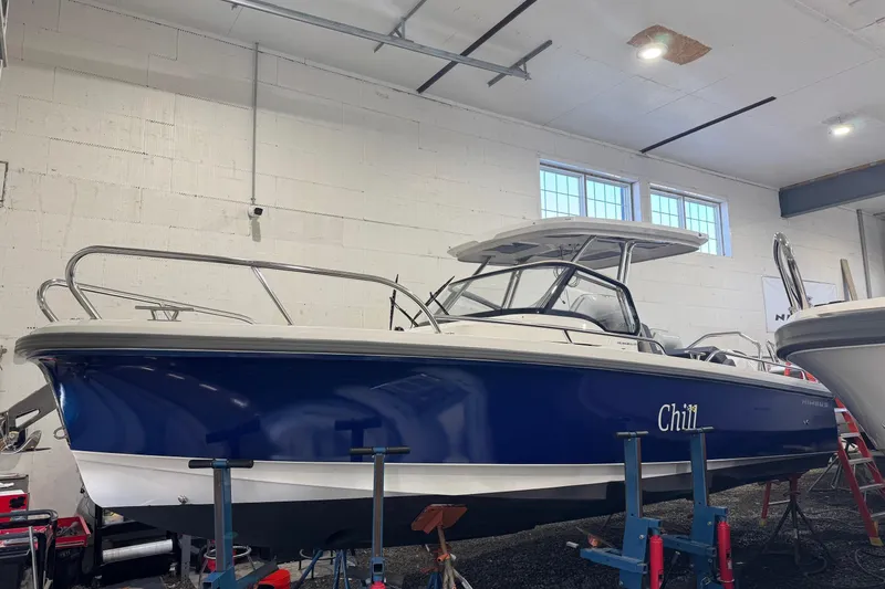 The Image of 2025 Nimbus Tender 8 boat named "Chill" on a lake with autumn trees. - 0