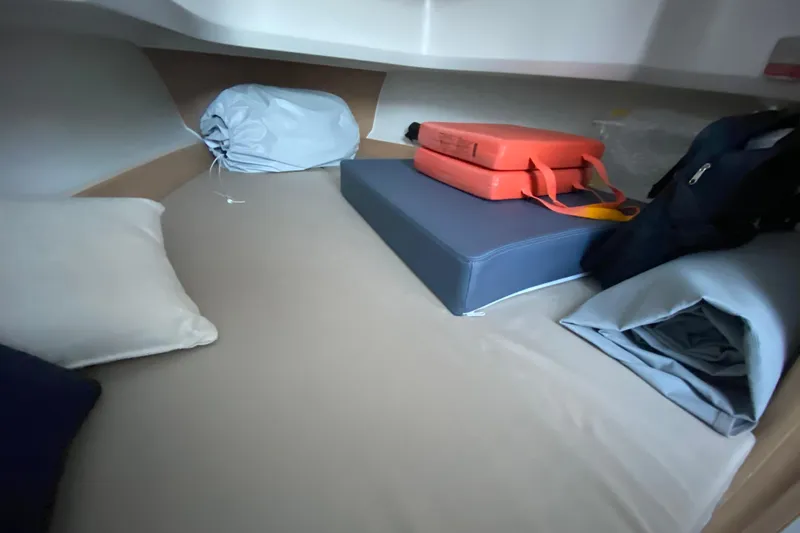 Slide: The Image of Cozy cabin interior of 2025 Nimbus Tender 8 with cushions and storage items. - 18