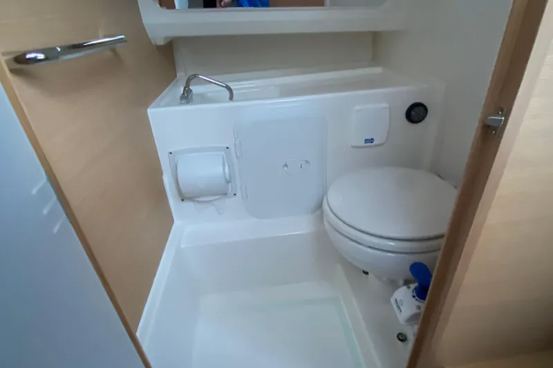 Slide: The Image of Compact bathroom in 2025 Nimbus Tender 8 boat, featuring toilet and sink. - 20