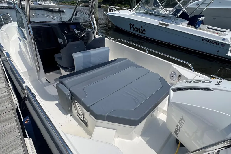 Slide: The Image of 2025 Nimbus Tender 8 boat named "Chill" cruising on a scenic lake. - 5