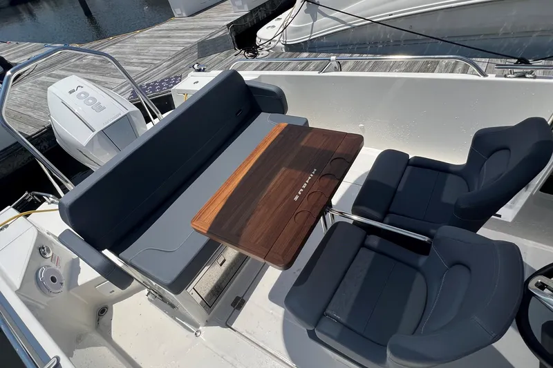 Slide: The Image of 2025 Nimbus Tender 8 boat cruising on a calm river with lush greenery. - 7