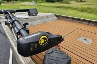 Slide: The Image of 2019 Edge Duck Boats 863 CC with trolling motor on wooden deck. - 6