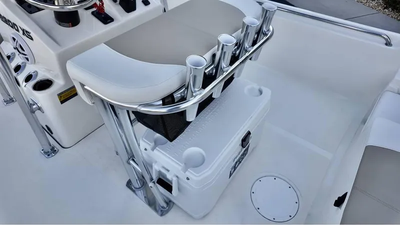 Slide: The Image of 2025 Bulls Bay 2200 XS boat interior with rod holders and cooler storage. - 11